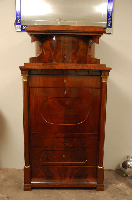 Mahogany, architectural upper section with demi-lune drawer, dentil frieze below and full drawer, drop-front fitted interior with marquetry drawers and doors, two side columns with gilt wood capitals.